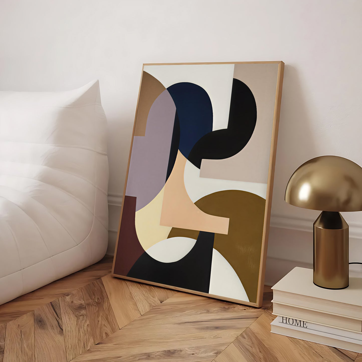 Abstract art piece on a wooden floor with a lamp and books in the background