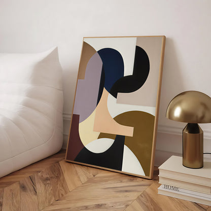 Abstract art piece on a wooden floor with a lamp and books in the background