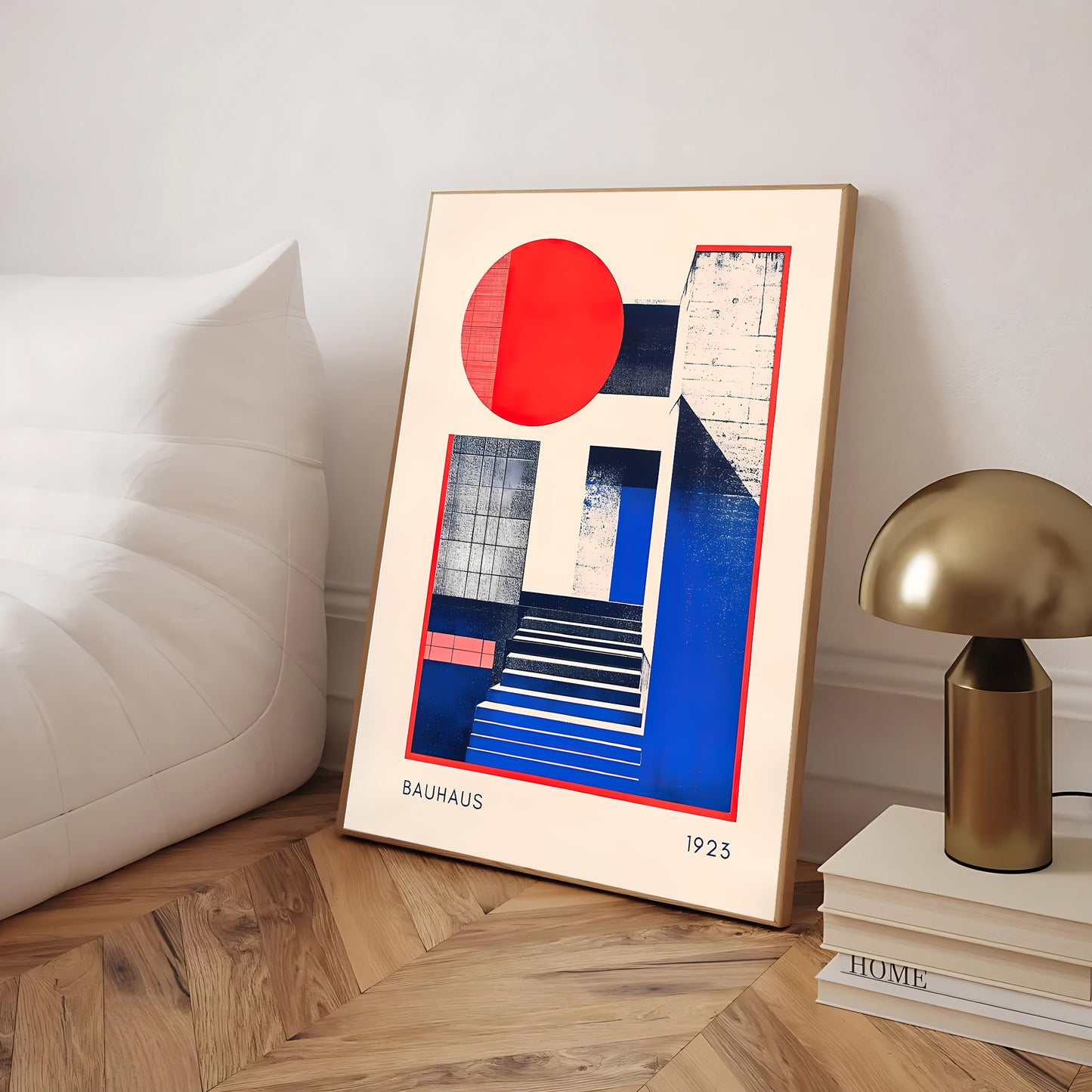 Framed Bauhaus art piece with a red circle and blue geometric shapes on a wooden floor.