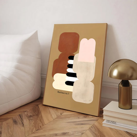 Abstract art piece on a wooden floor with a lamp and books in the background