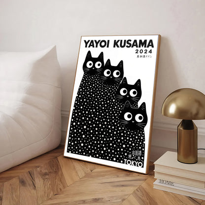 Framed Yayoi Kusama cats artwork with black cats design on a wooden floor.