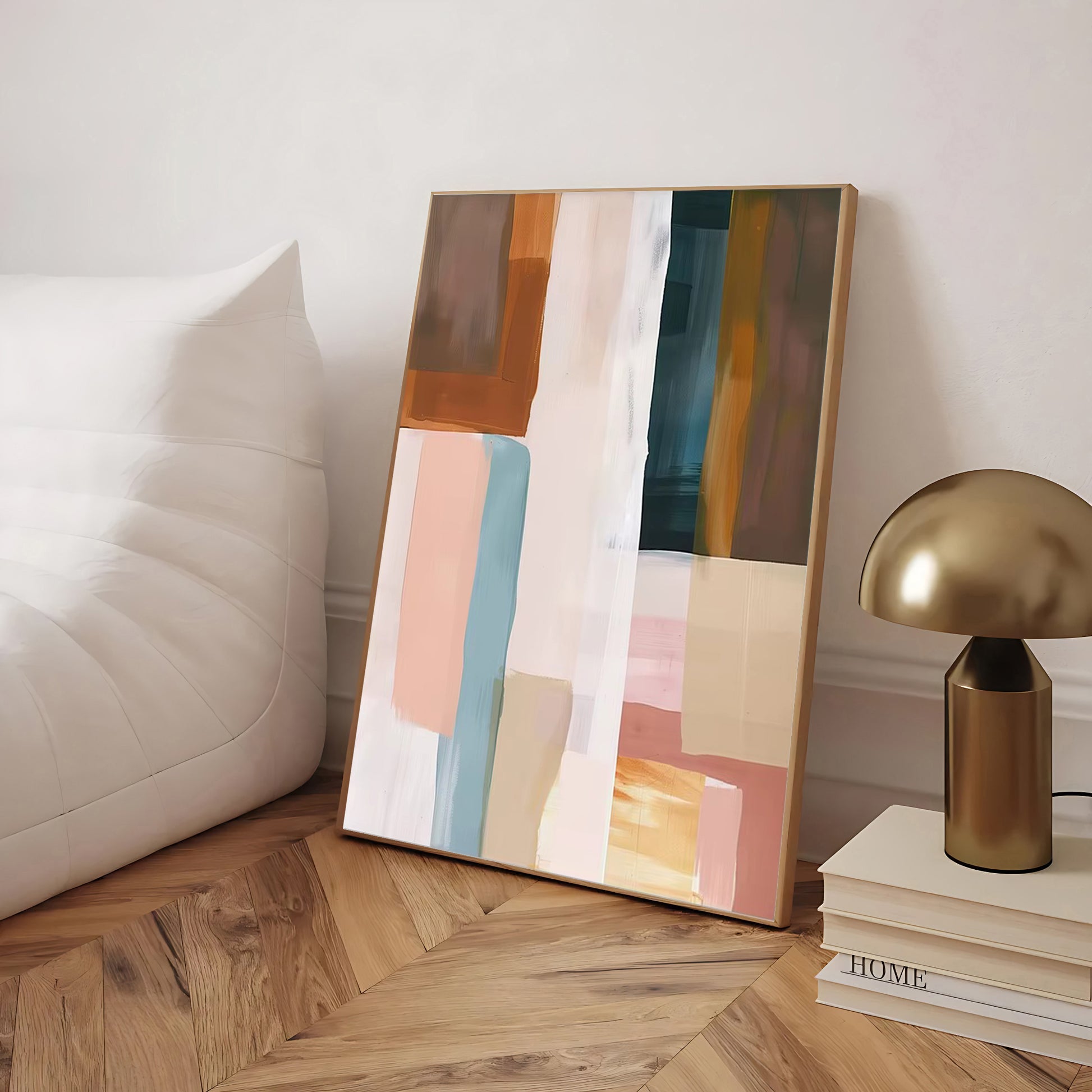 Abstract art piece on a wooden floor with a lamp and books in the background