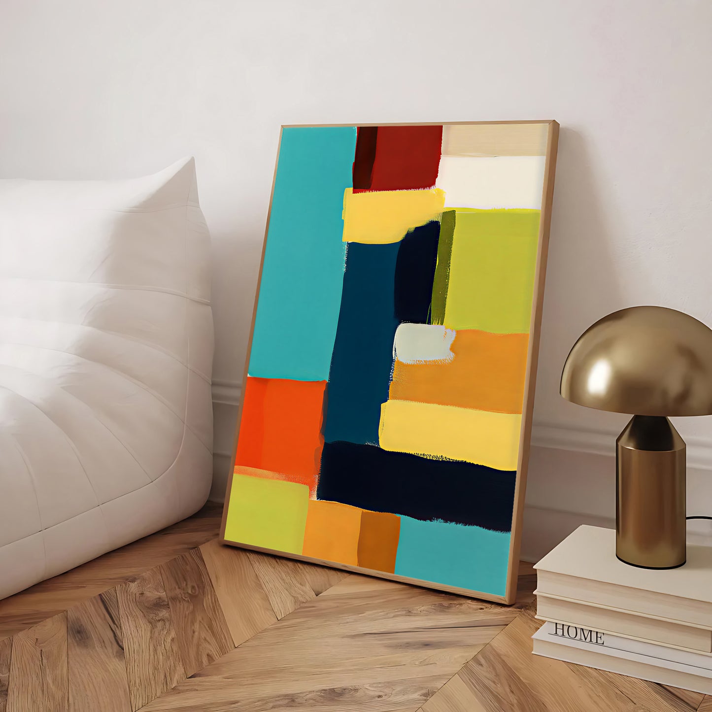 Colorful abstract painting on a wooden floor with a lamp and books in the background