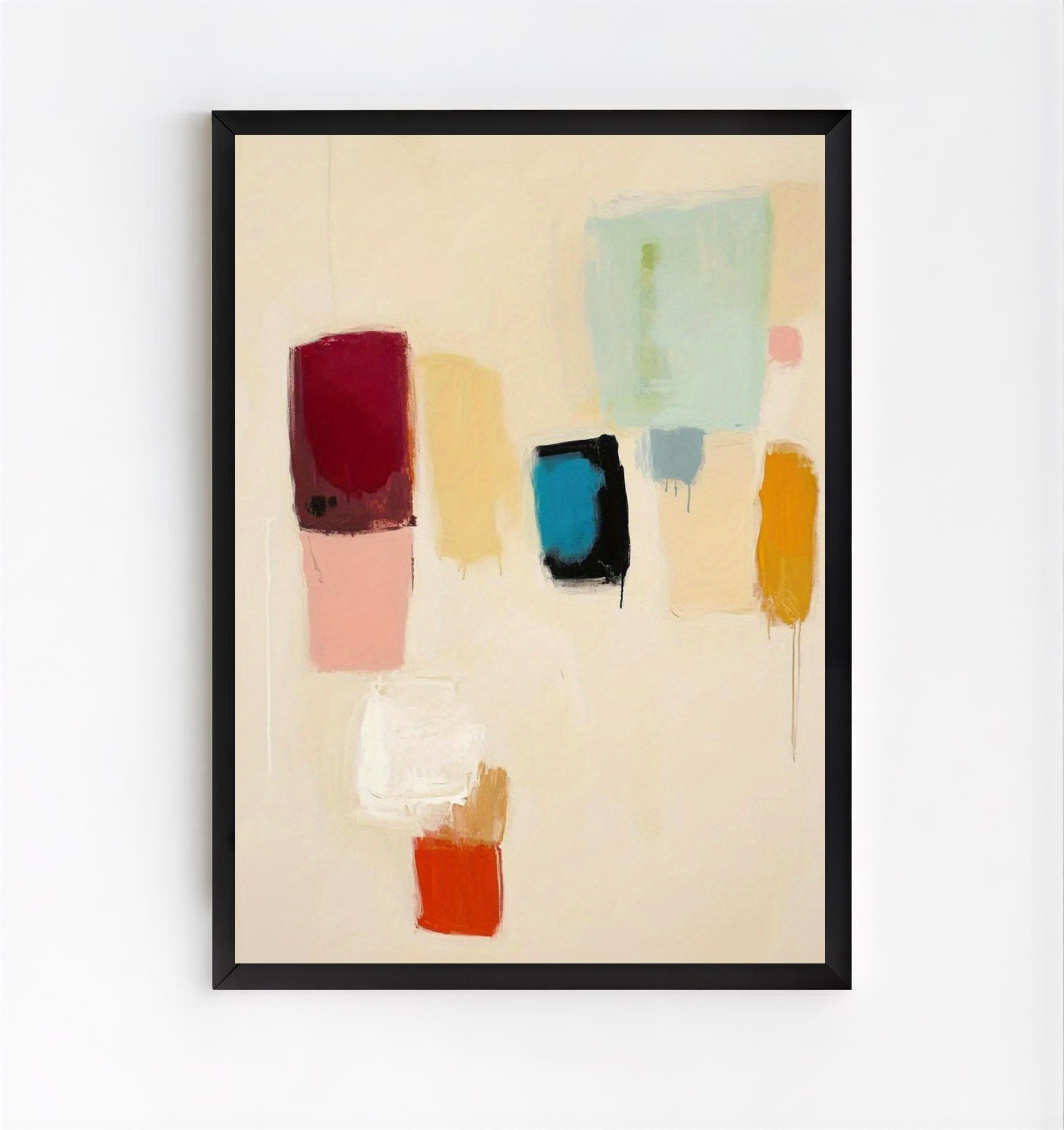 Framed abstract art with colorful blocks on a beige background