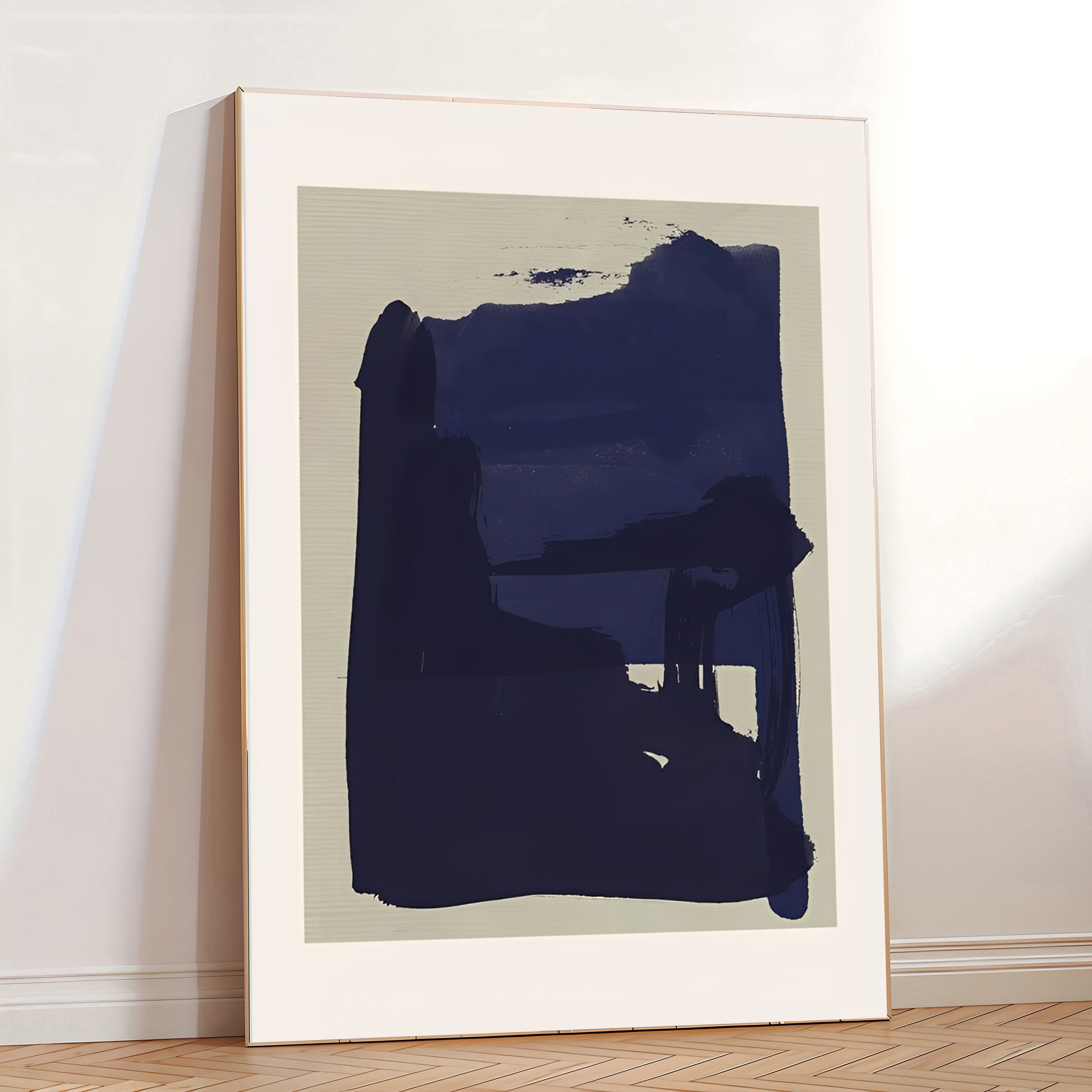 Abstract art print in a white frame on a wall.