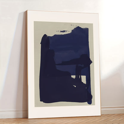 Abstract art print in a white frame on a wall.