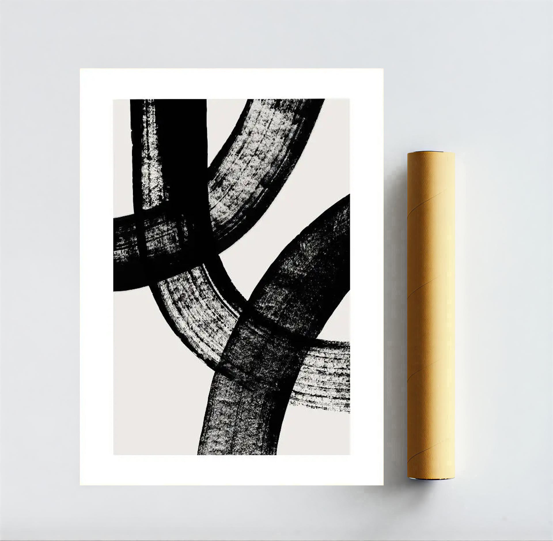 Abstract black and white art print on a gray background with a gold roll of paper.