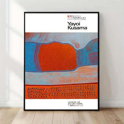 Framed artwork with abstract design and 'Yayoi Kusama' text on a white wall.