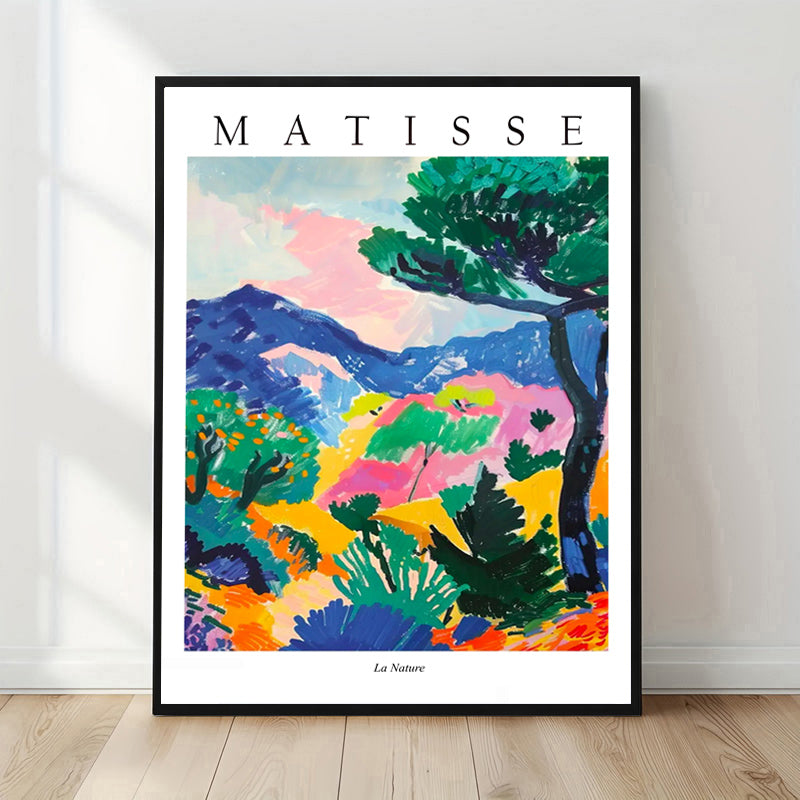 Framed Matisse art print of a colorful landscape on a white wall.