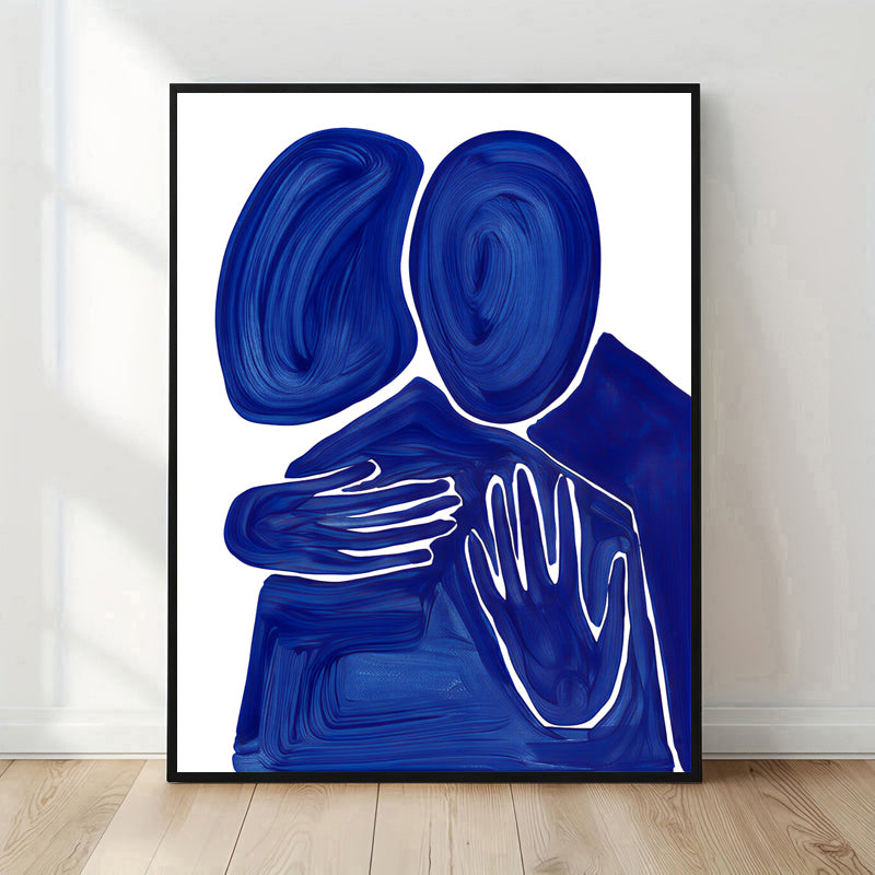 Framed abstract artwork with blue and white design on a white wall.