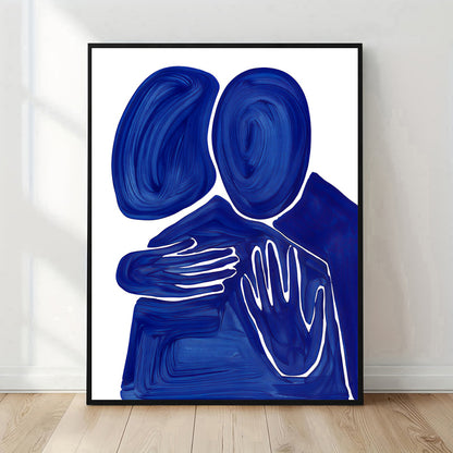 Framed abstract artwork with blue and white design on a white wall.