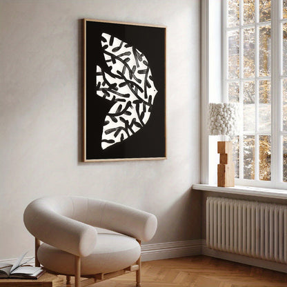 Modern interior with a black and white abstract wall art piece, a beige armchair, and a window.