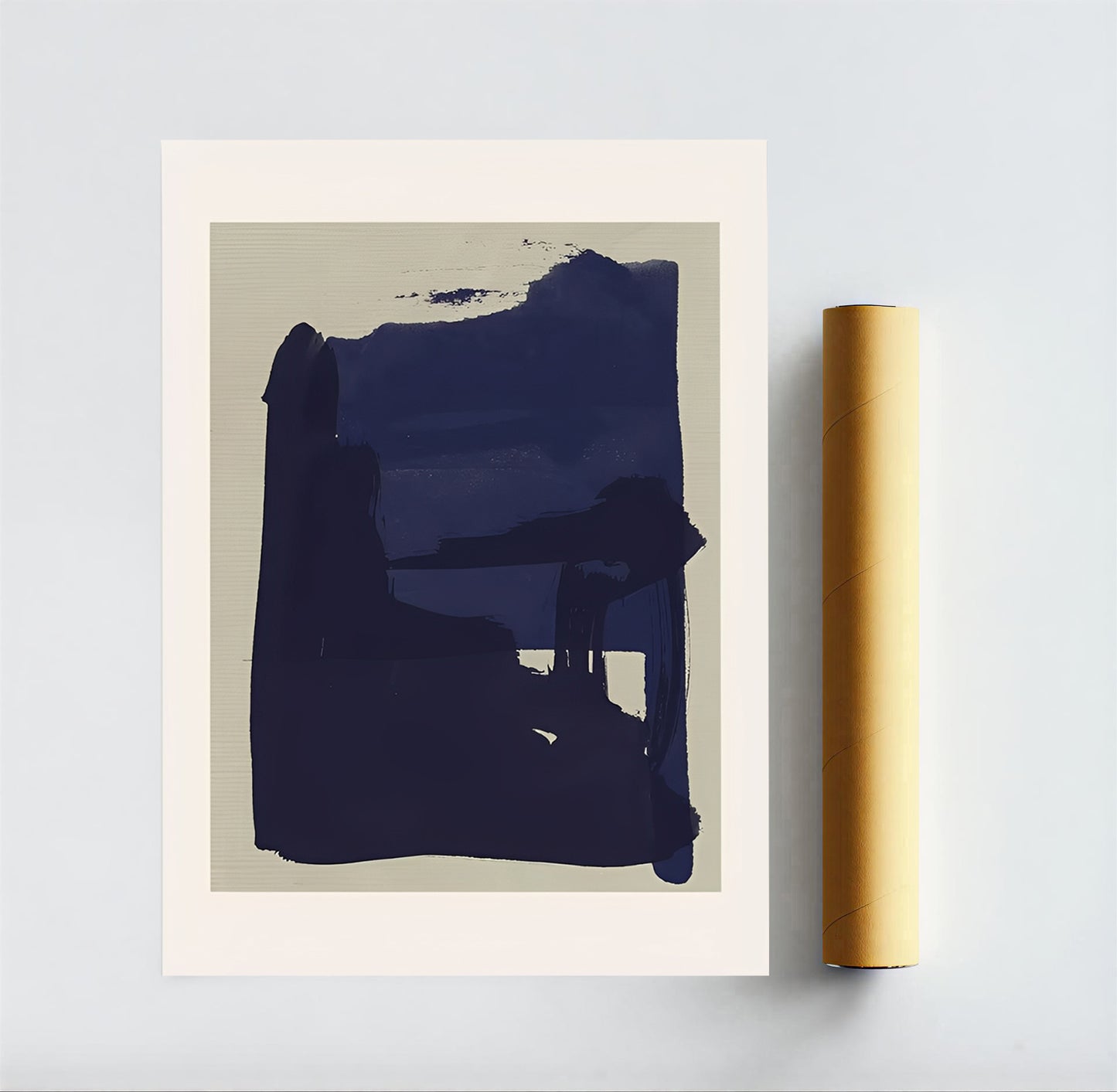 Abstract art print with a blue shape on beige background, framed and leaning against a light gray wall.