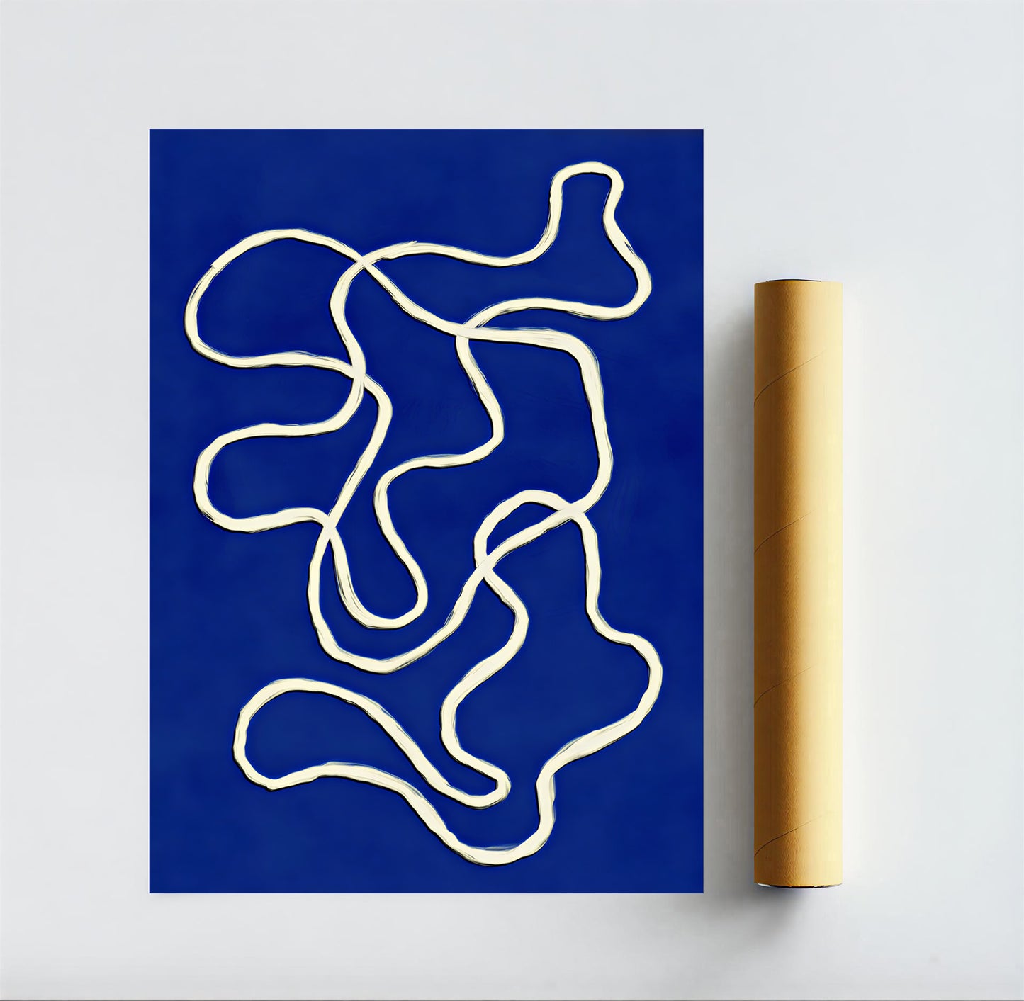 Abstract art print with white lines on a blue background, next to a roll of paper.