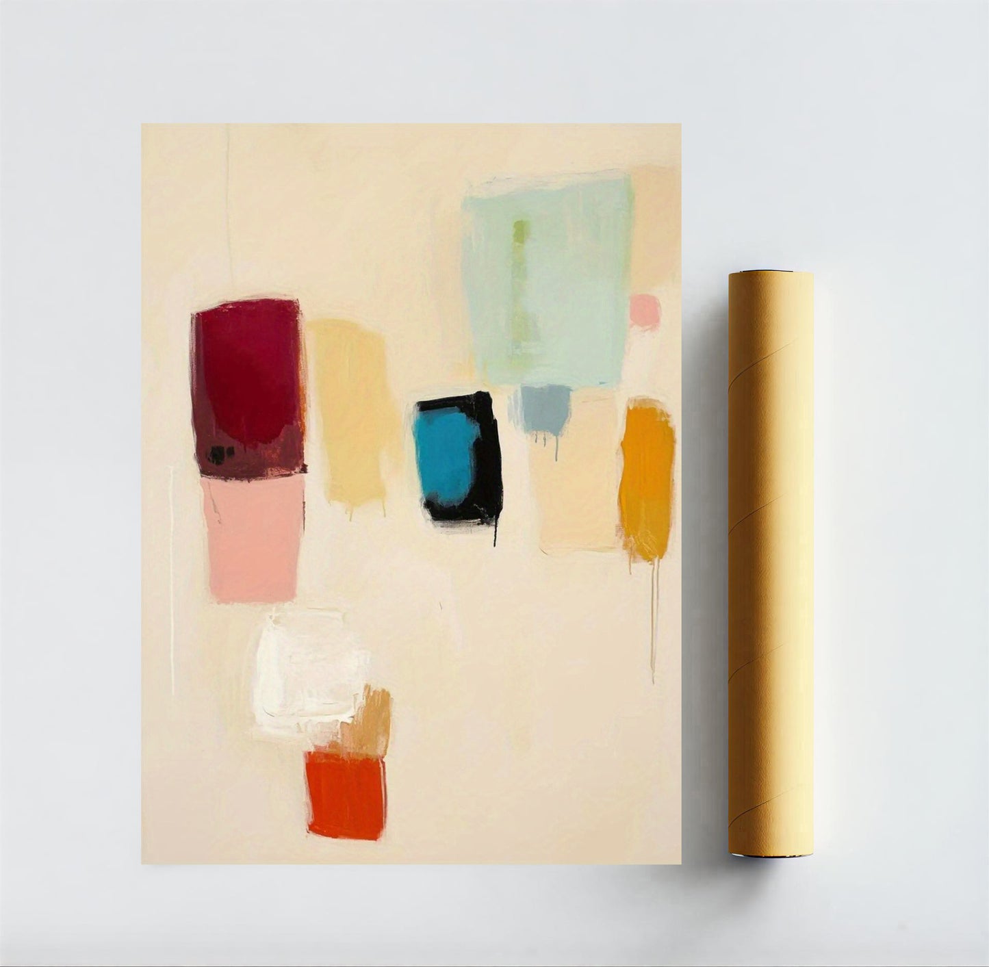 Abstract art piece with colorful square patches on a beige background, next to a roll of paper.
