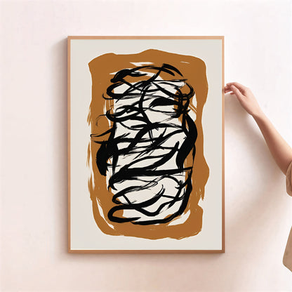 Abstract art print with black and white brush strokes on a brown background, framed in wooden border.