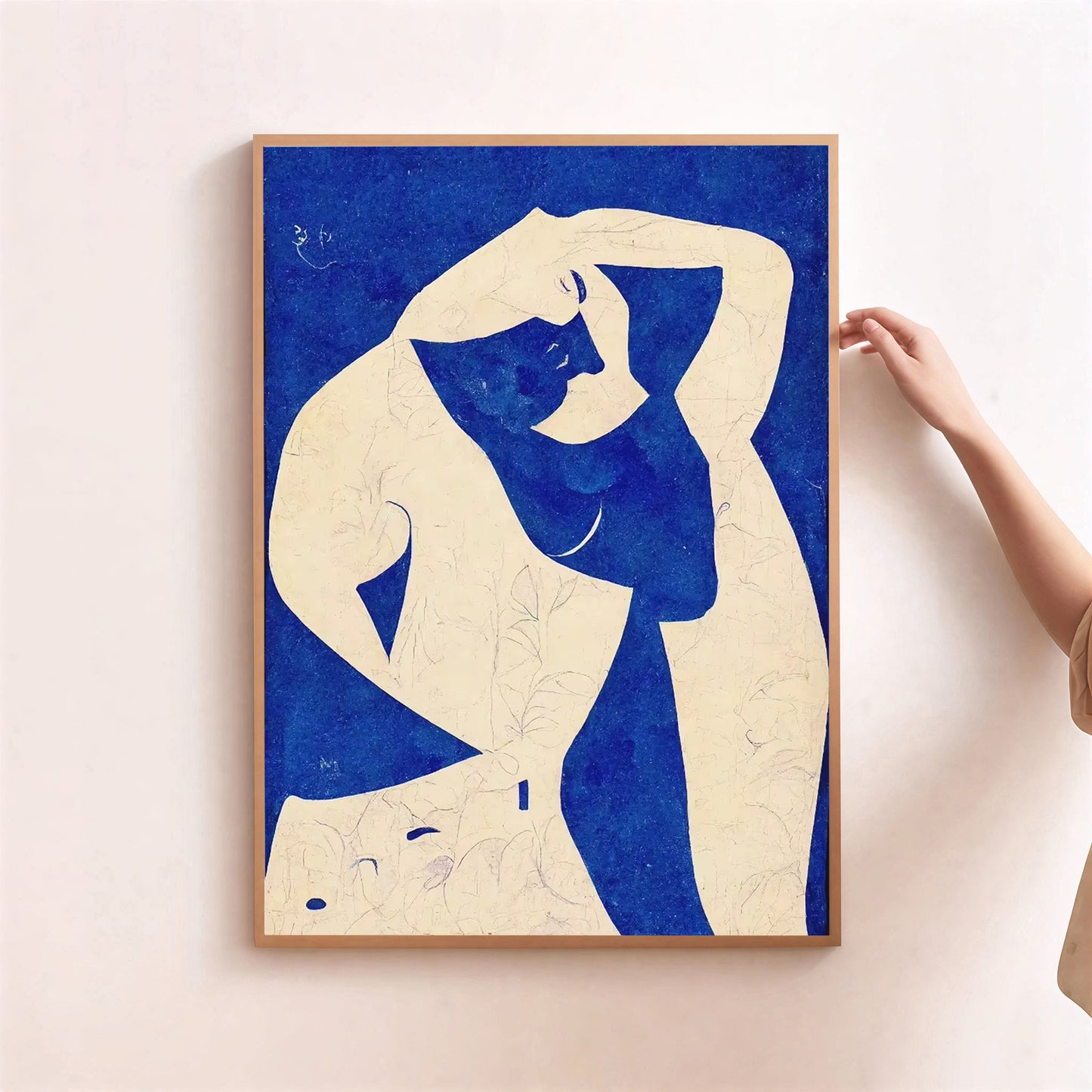 Framed artwork of a stylized figure with blue and beige colors on a light background