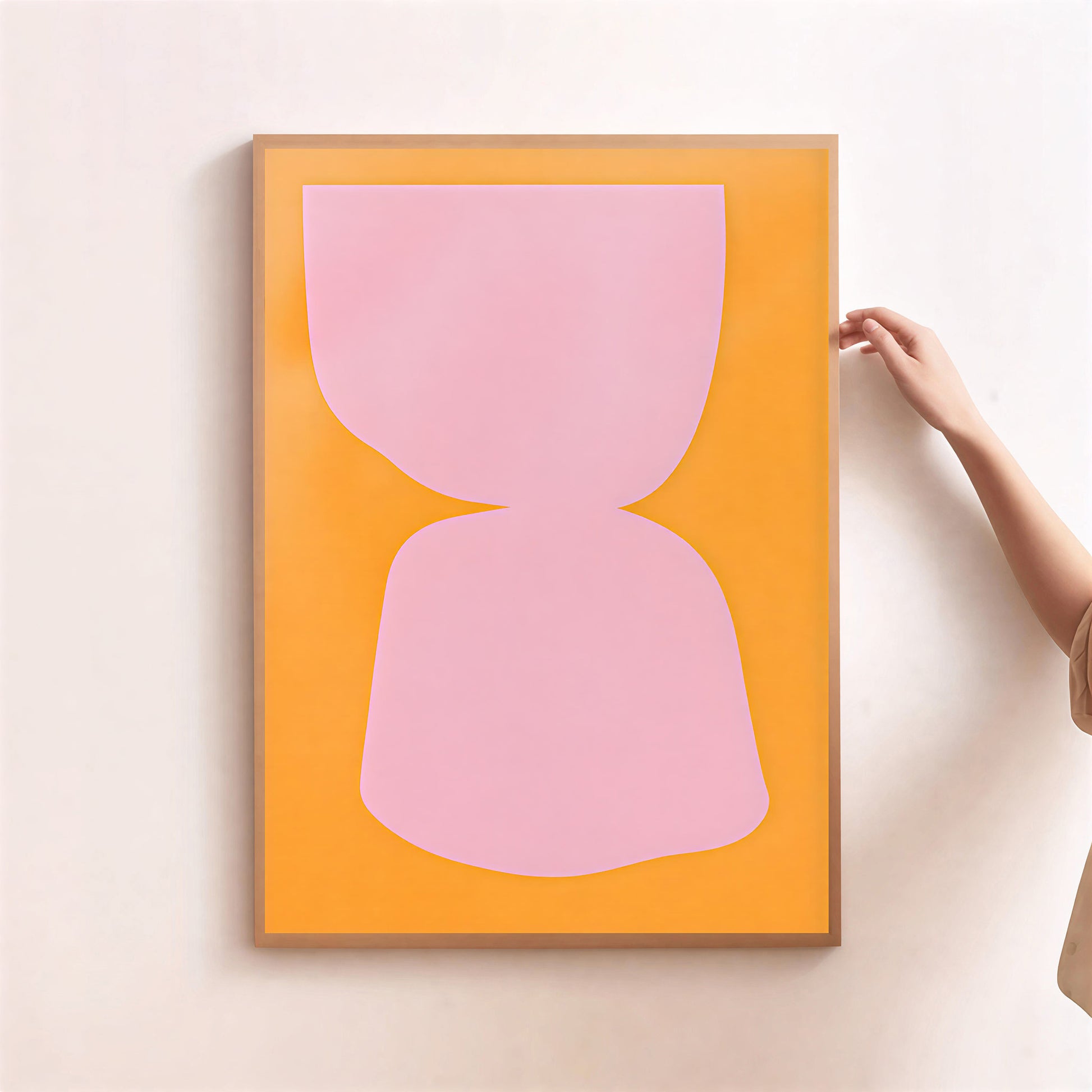 Framed abstract art with pink shape on orange background