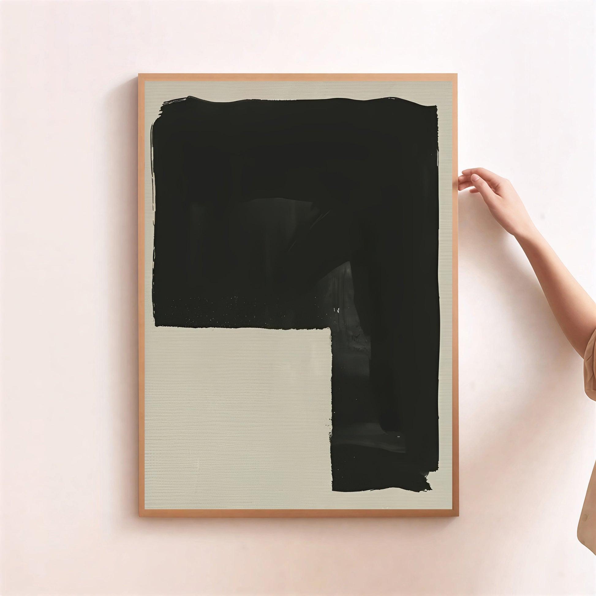 Framed abstract art piece with a large black brushstroke on a light background