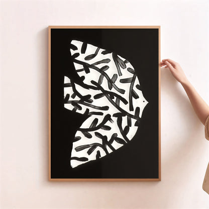 Framed bird abstract art print with black and white pattern on a light pink wall.
