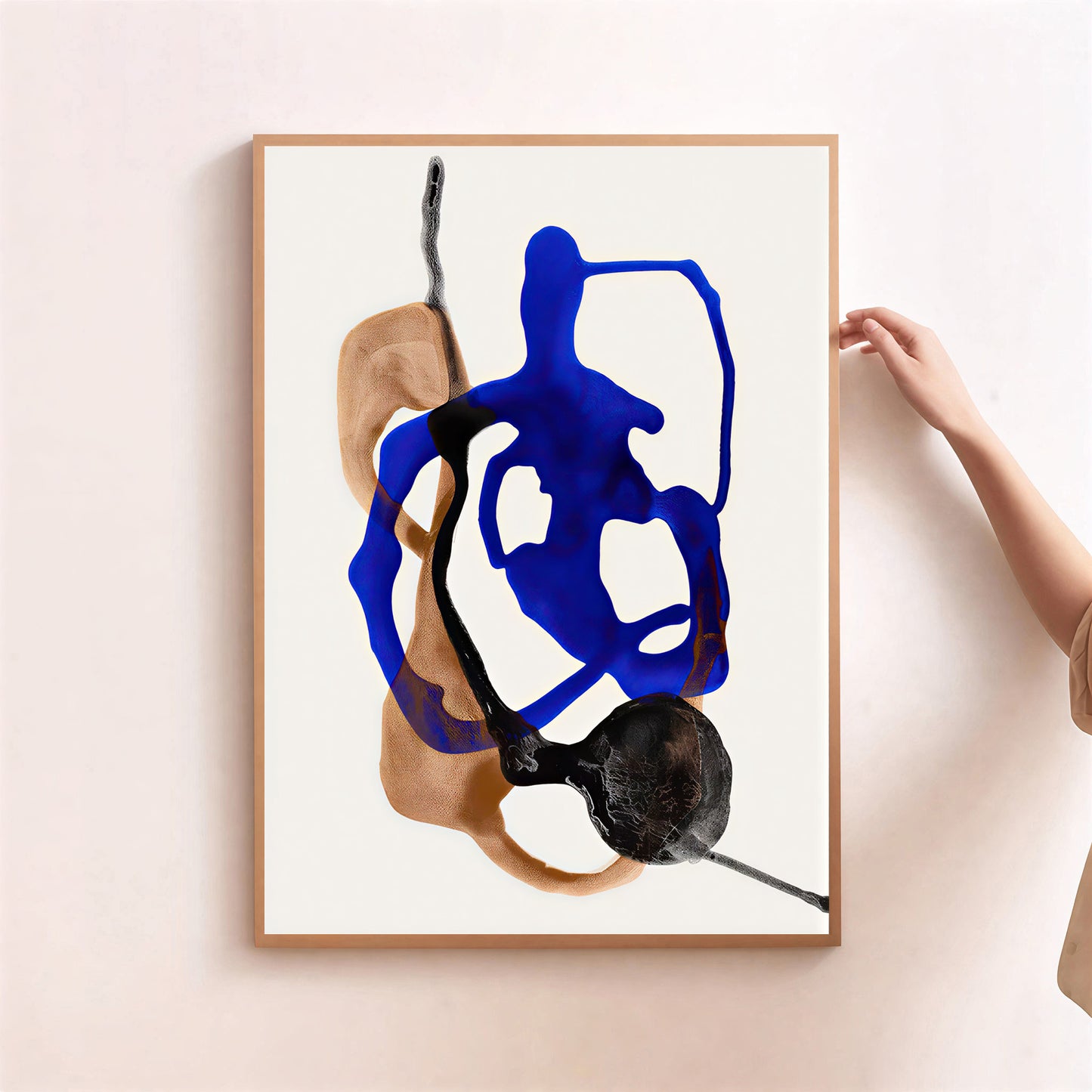 Modern abstract wall art print blue and neutral shapes on a light pink wall.