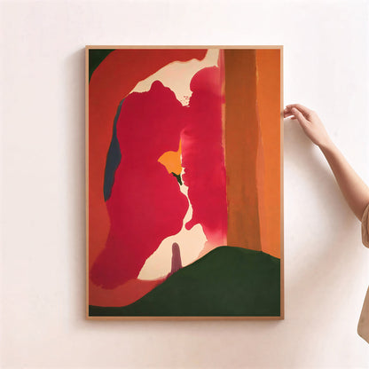 Abstract art print with a red and green color scheme on a white wall.