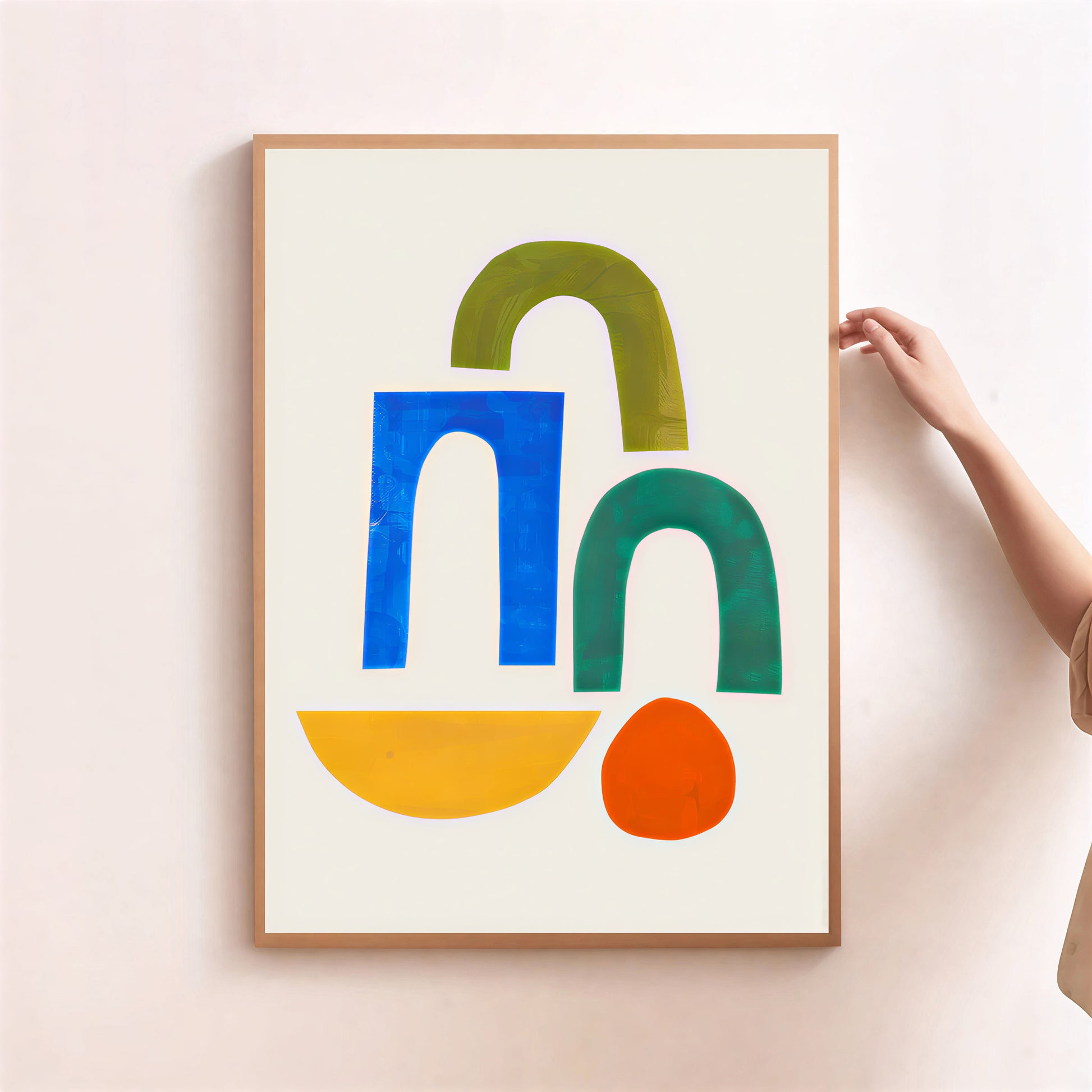 Framed abstract art print with colorful shapes on a light background