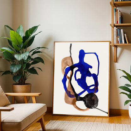 Abstract art print in a living room setting with plants and a bookshelf.