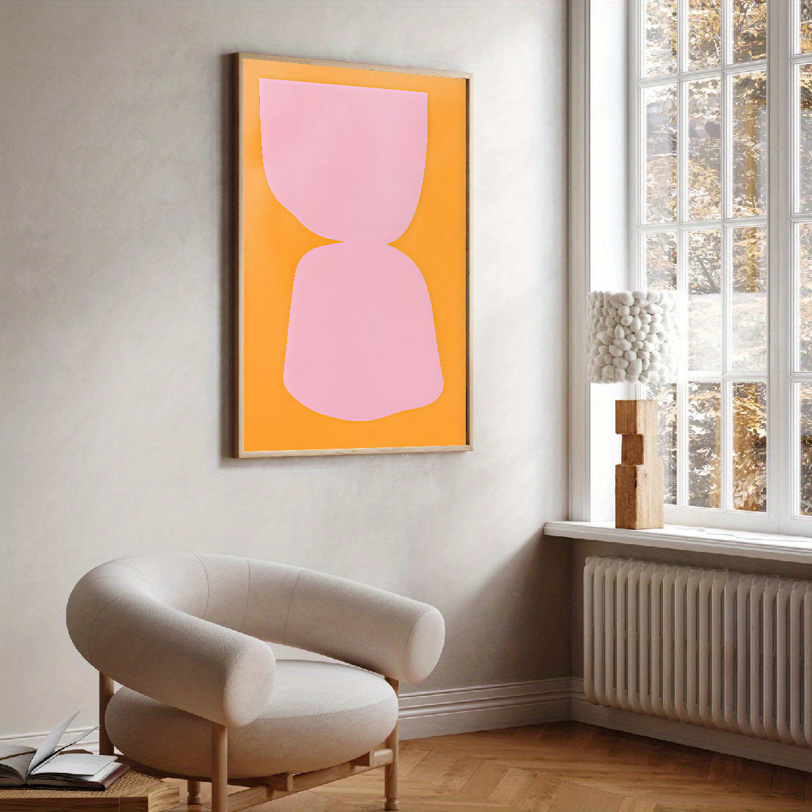 Modern interior with a pink abstract artwork on an orange background, a beige armchair, and a window.