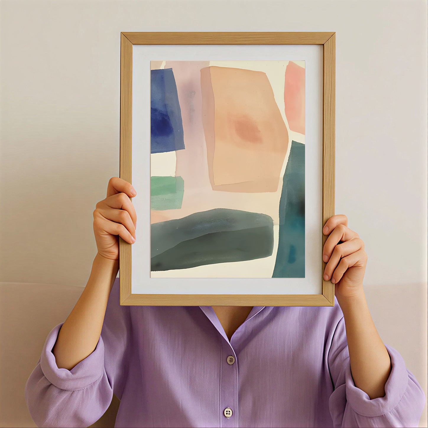 Person holding a framed abstract art piece against their face with a plain background