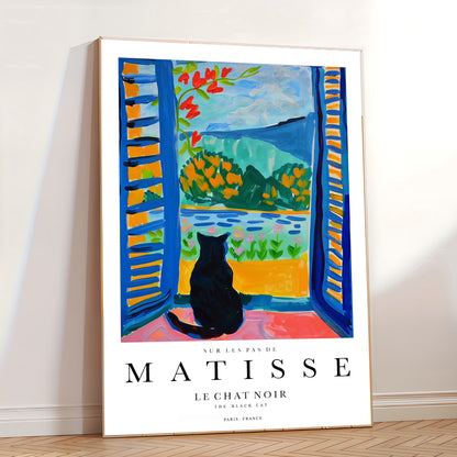 Framed Matisse art print of 'Le Chat Noir' with a black cat by an open window.