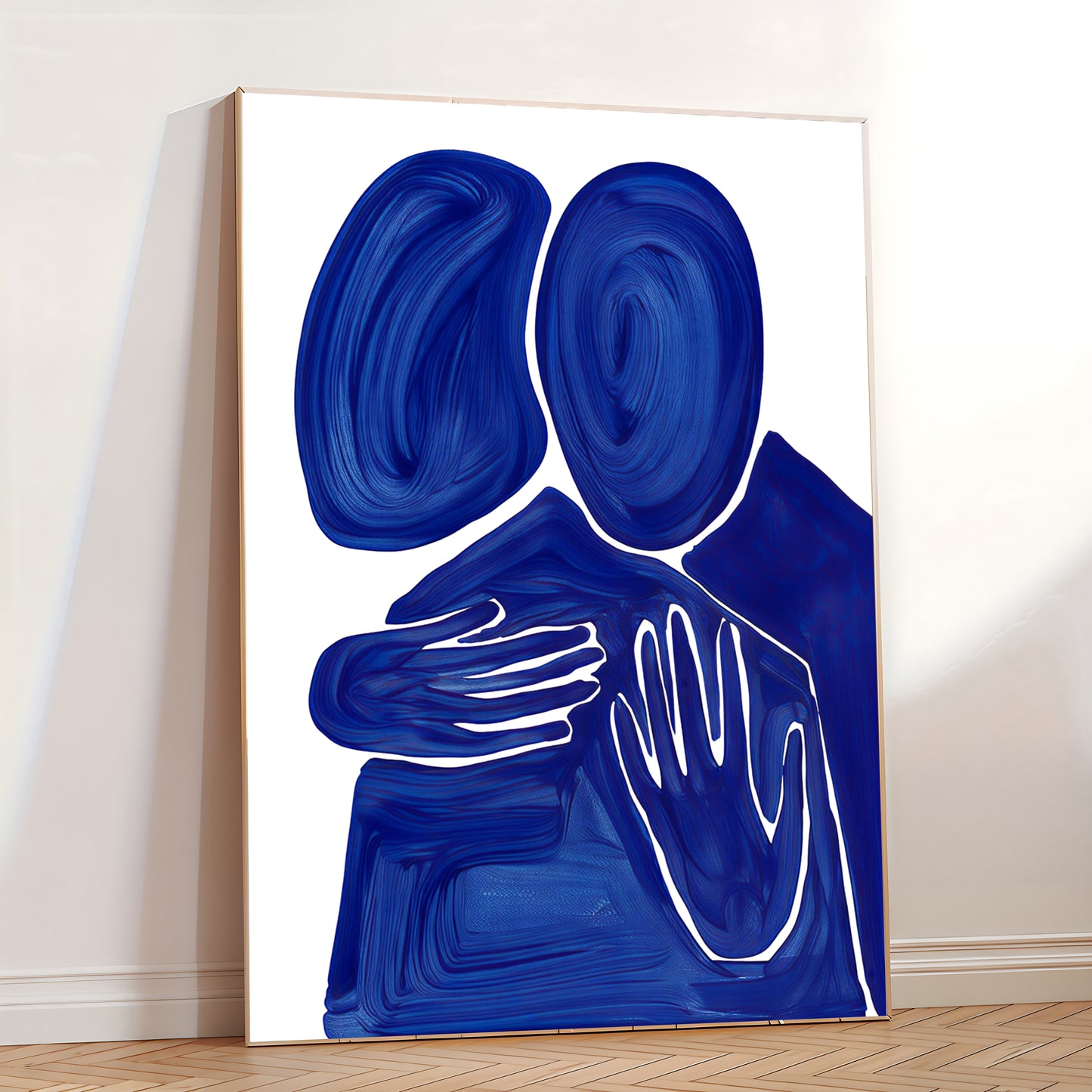 Abstract art piece with blue and white shapes on a white wall.