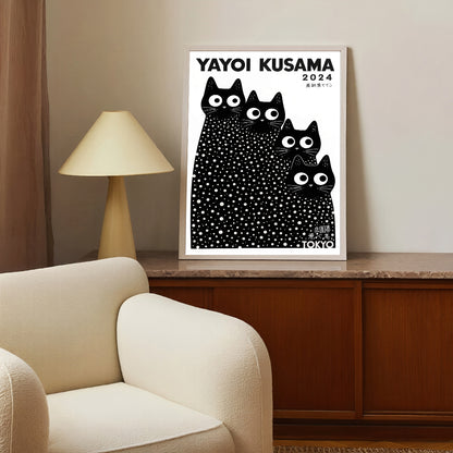 Framed Yayoi Kusama poster with black and white cat illustration in a living room setting.