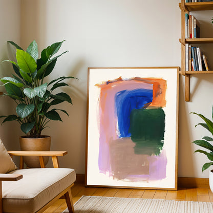Abstract art print in a living room setting with plants and a bookshelf.