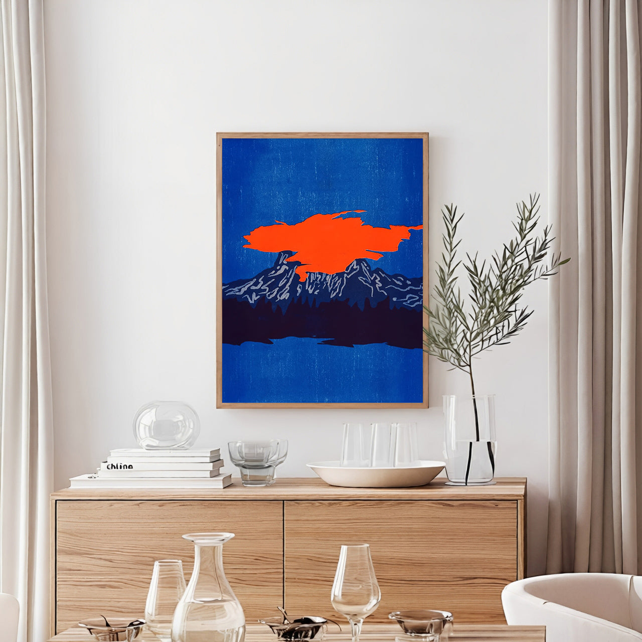 Modern interior with a wooden cabinet, decorative items, and a colorful abstract painting on the wall.