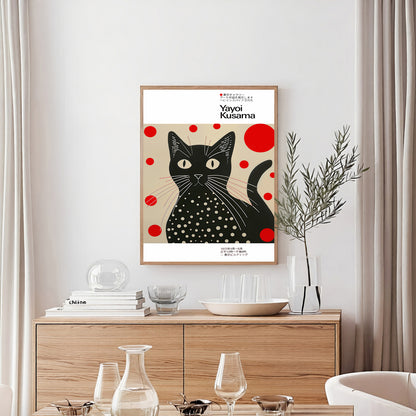 Framed artwork of a black cat with red dots on a beige background in a modern interior setting.