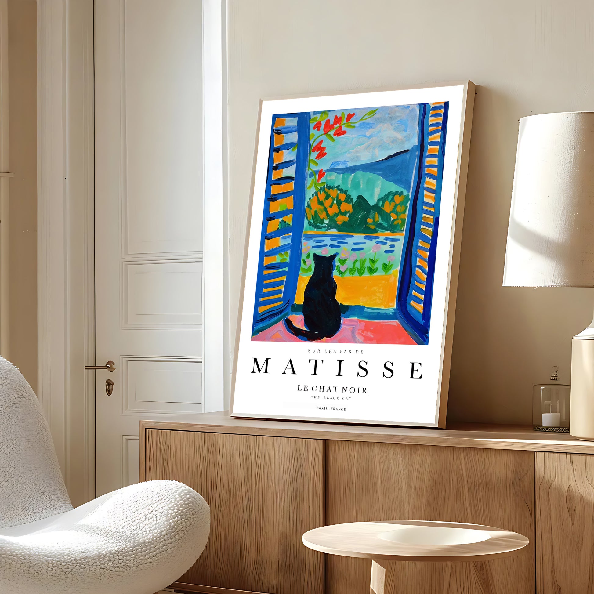 Framed Matisse art print on a wall in a room with a chair and lamp.