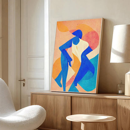 Abstract artwork of two figures on a wall in a modern room with a chair and lamp.