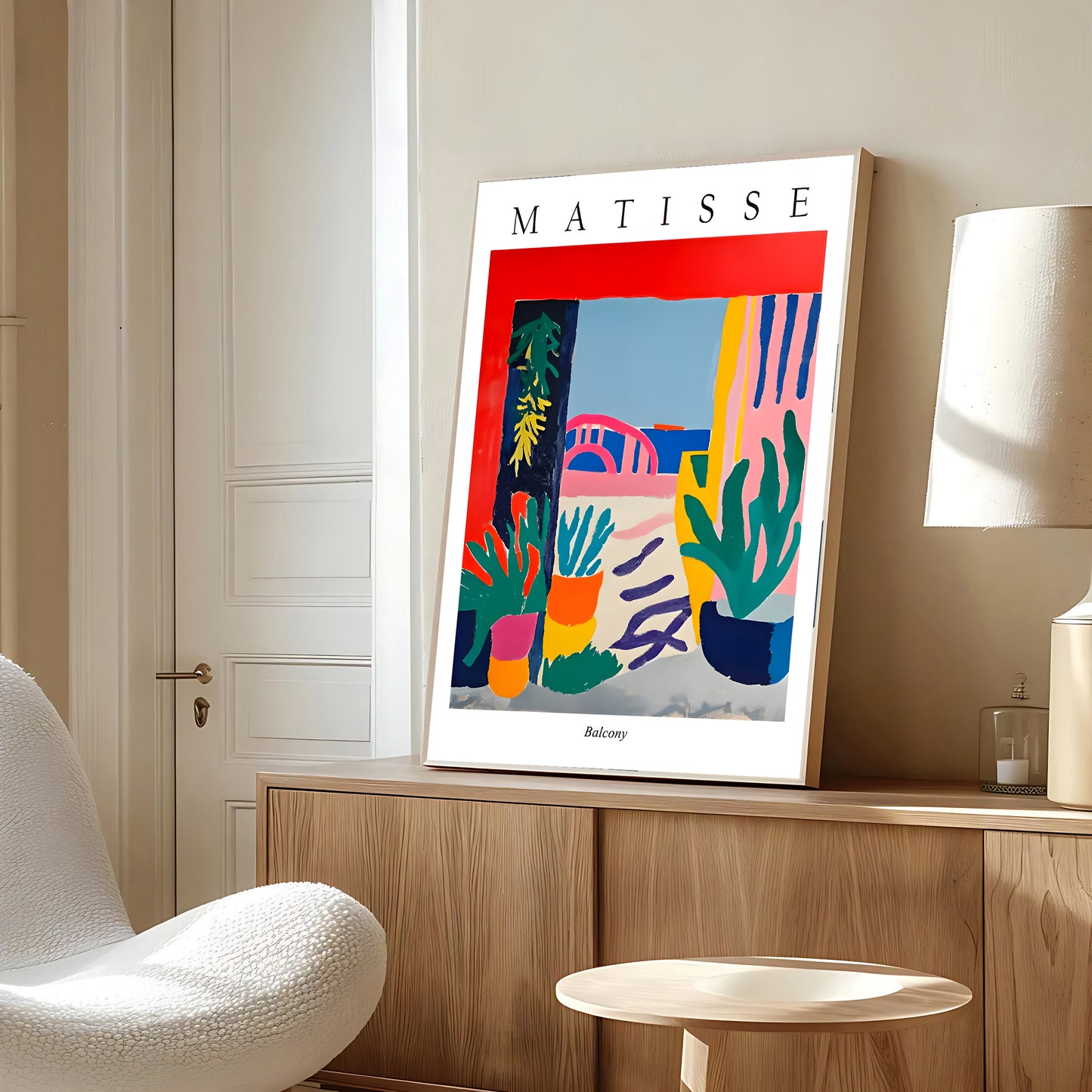 Framed Matisse artwork on a wall in a modern room with a chair and lamp.