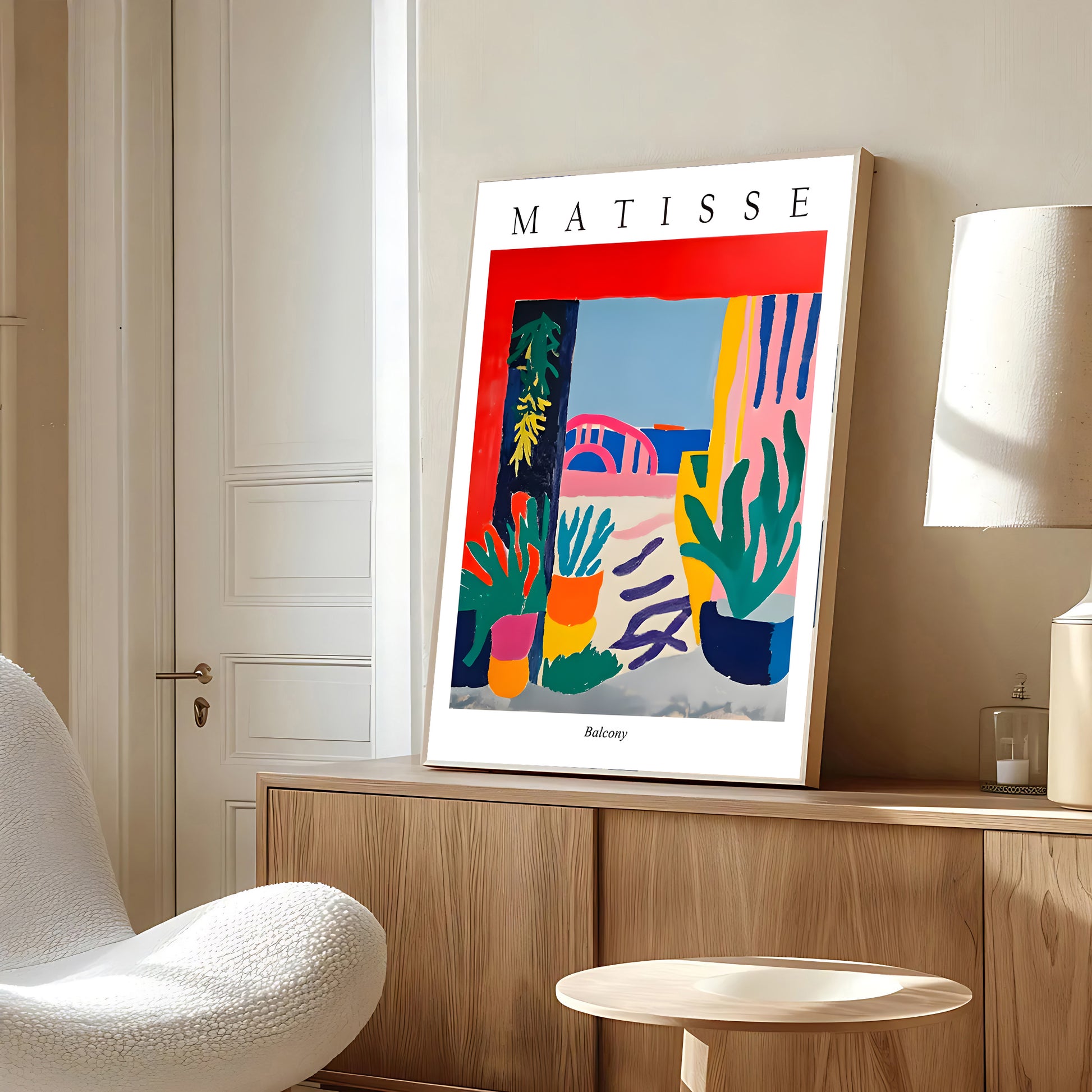 Framed Matisse artwork on a wall in a modern room with a chair and lamp.