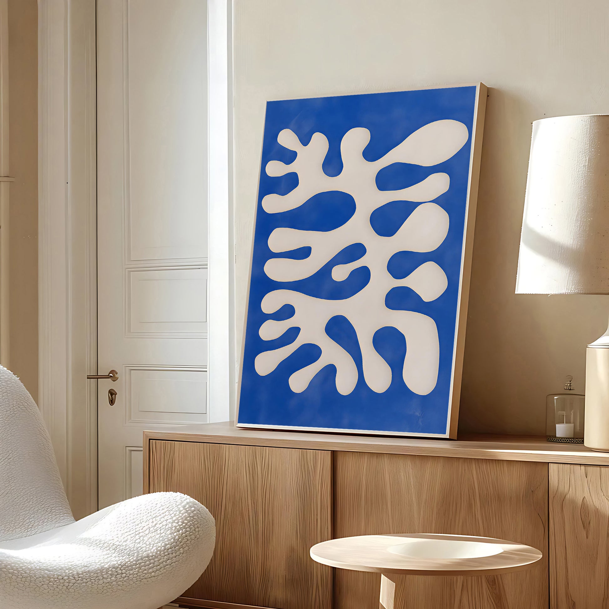 Modern interior with a blue and white abstract painting on a wooden cabinet.