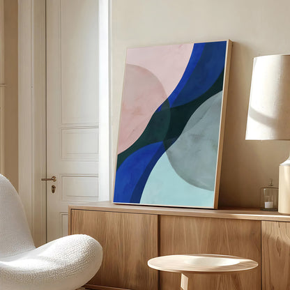 Abstract art piece on a wooden shelf in a room with a chair and lamp.