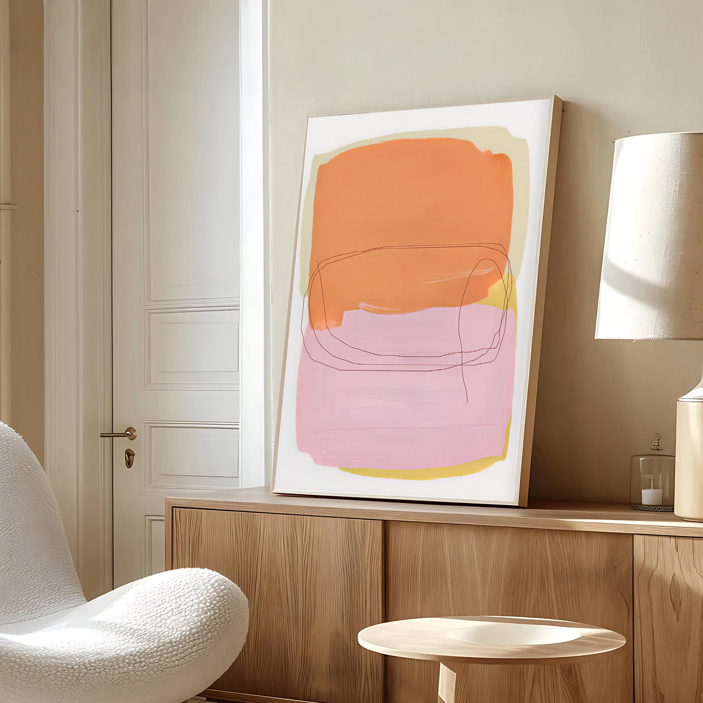 Abstract art piece on a wall in a modern interior setting with a chair and lamp.