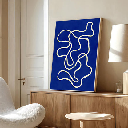 Abstract artwork with wavy lines on a blue background in a modern room.