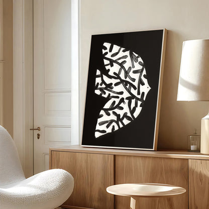 Modern interior with abstract black and white artwork on a wooden cabinet.