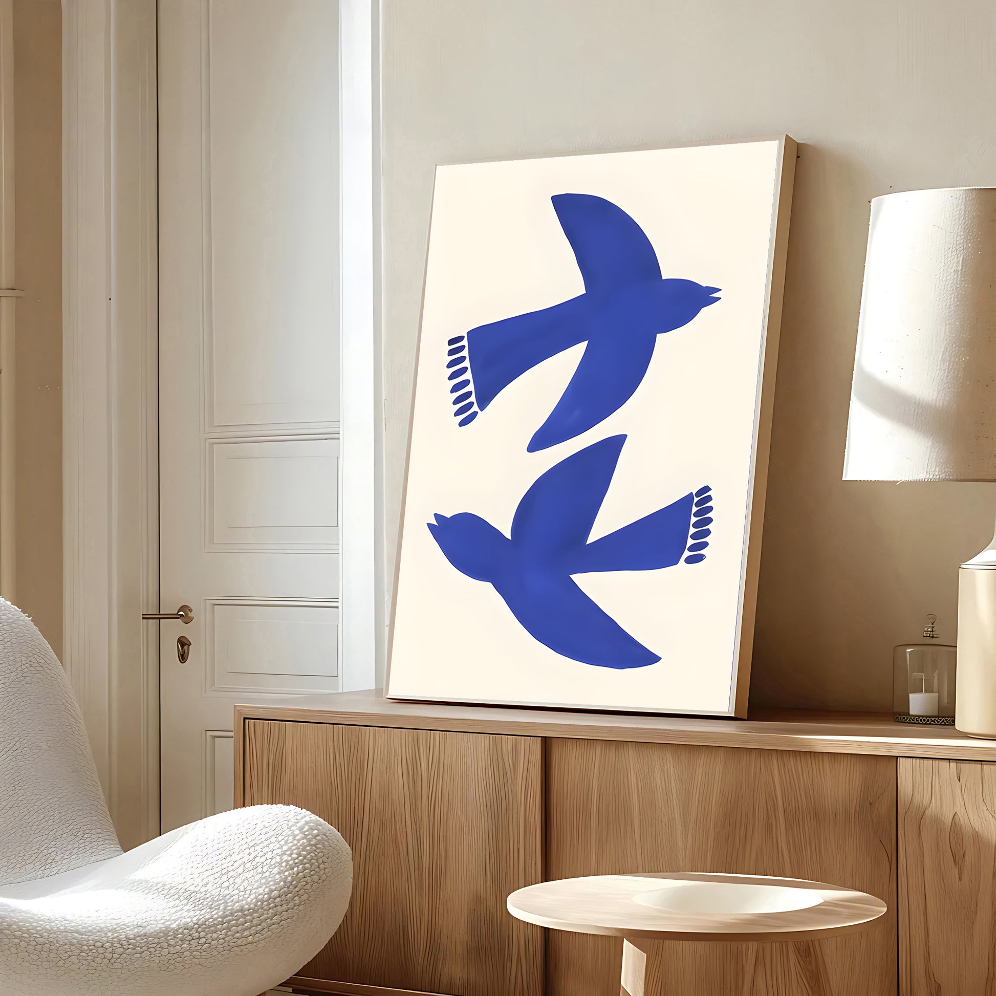 Modern interior with a wooden cabinet, white chair, and abstract art featuring blue birds.