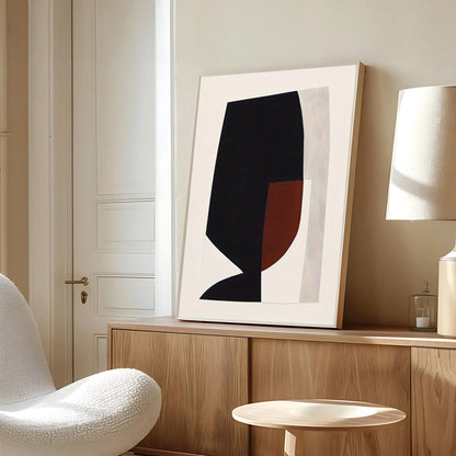 Abstract art piece on a wooden shelf in a room with a white chair and lamp.