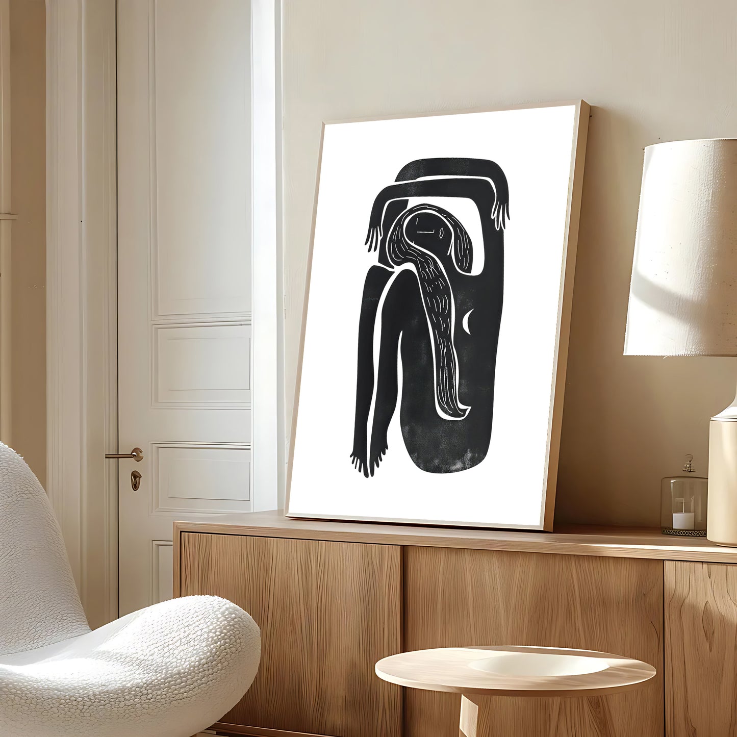 Abstract black and white artwork on a wooden shelf in a modern room.