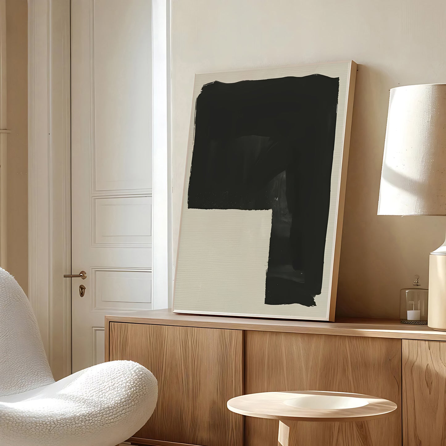Modern interior with abstract art on a wooden cabinet, white chair, and lamp.