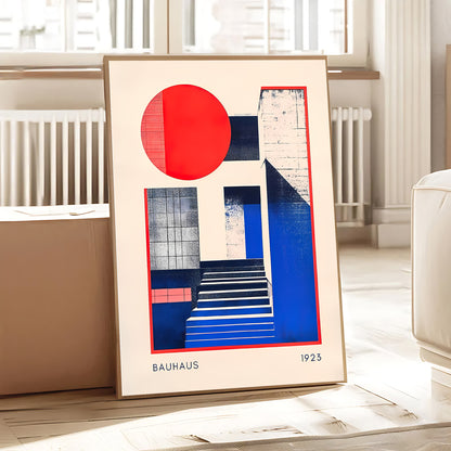 Framed Bauhaus art print with geometric design on a table.